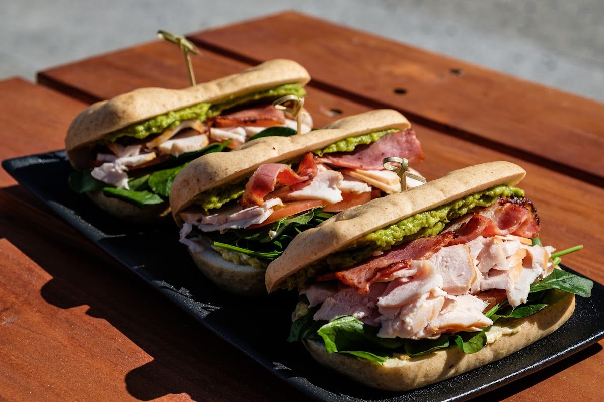 Filled baps with bacon and chicken on a serving board